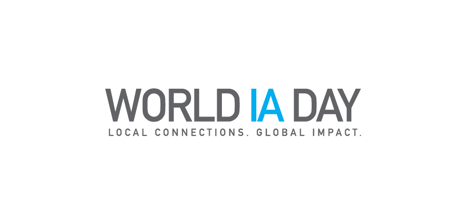 World IA Day logo. In Gray all capital letter with IA in aqua, followed by the tagline, “Local Connections, Global Impact.”
